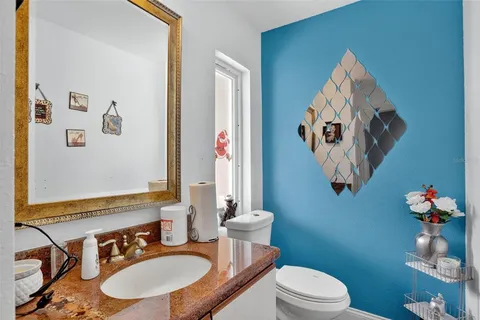 a bathroom with a sink mirror and toilet