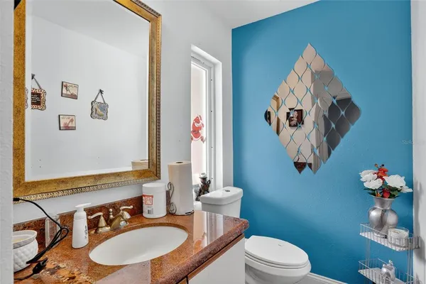 a bathroom with a sink mirror and toilet