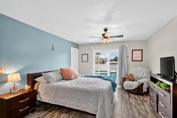 a bedroom with a bed and a ceiling fan