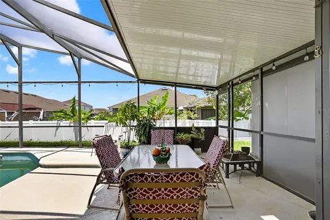 a dining room with furniture and garden view