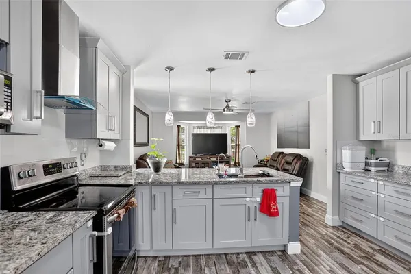 a kitchen with a sink stove and cabinets