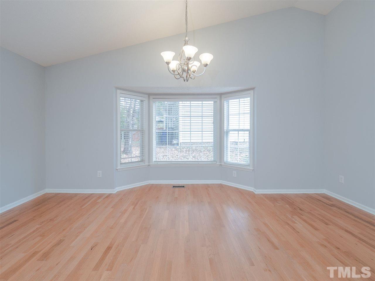 6816 Coventry Ridge Road Raleigh, NC 27616 - Photo 8 of 26 a view of an empty room with wooden floor and a window