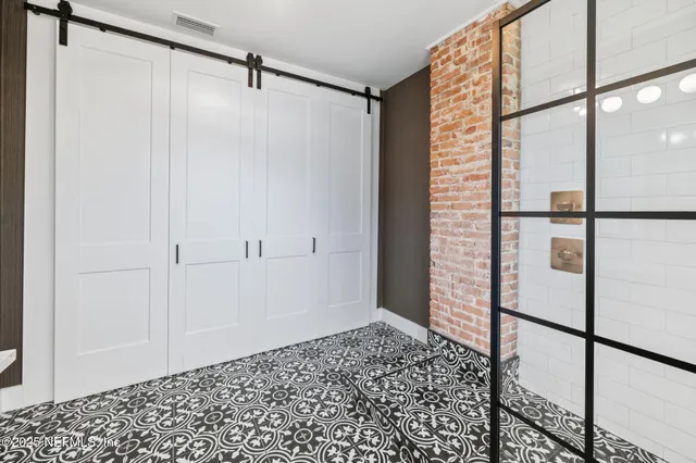 a bathroom with a double vanity sink toilet and a mirror