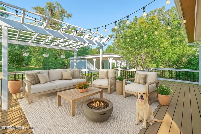 a view of a patio with couches table and chairs and potted plants