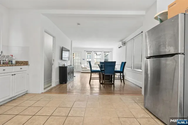 a kitchen with stainless steel appliances a refrigerator and dining table