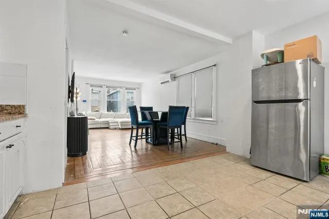 a dining room with furniture and a refrigerator