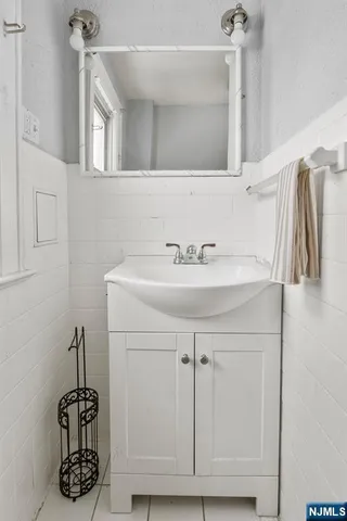 a bathroom with a sink vanity and a mirror