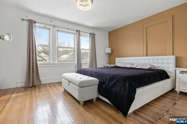 a spacious bedroom with a bed and a large window
