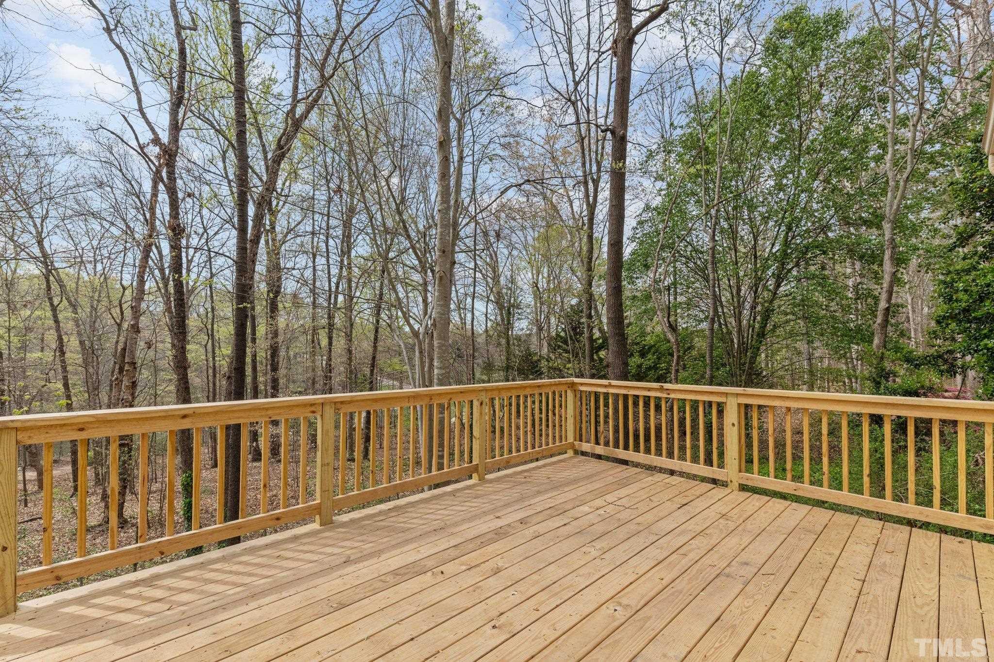 4006 Arckelton Drive, Unit 4006 & 4004 Raleigh, NC 27612 - Photo 12 of 34 a view of deck with wooden floor and fence