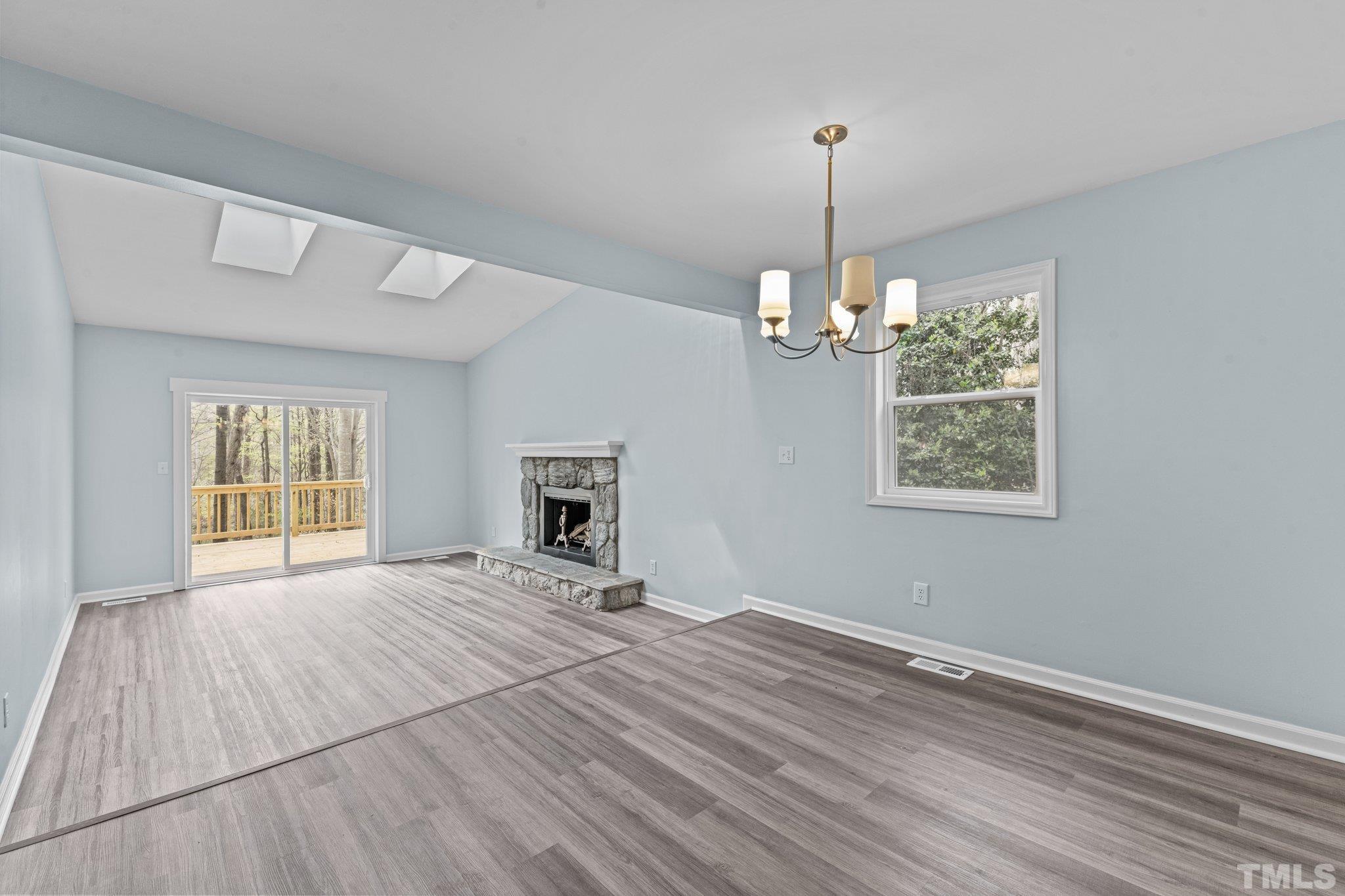 4006 Arckelton Drive, Unit 4006 & 4004 Raleigh, NC 27612 - Photo 19 of 34 a view of empty room with wooden floor and fan