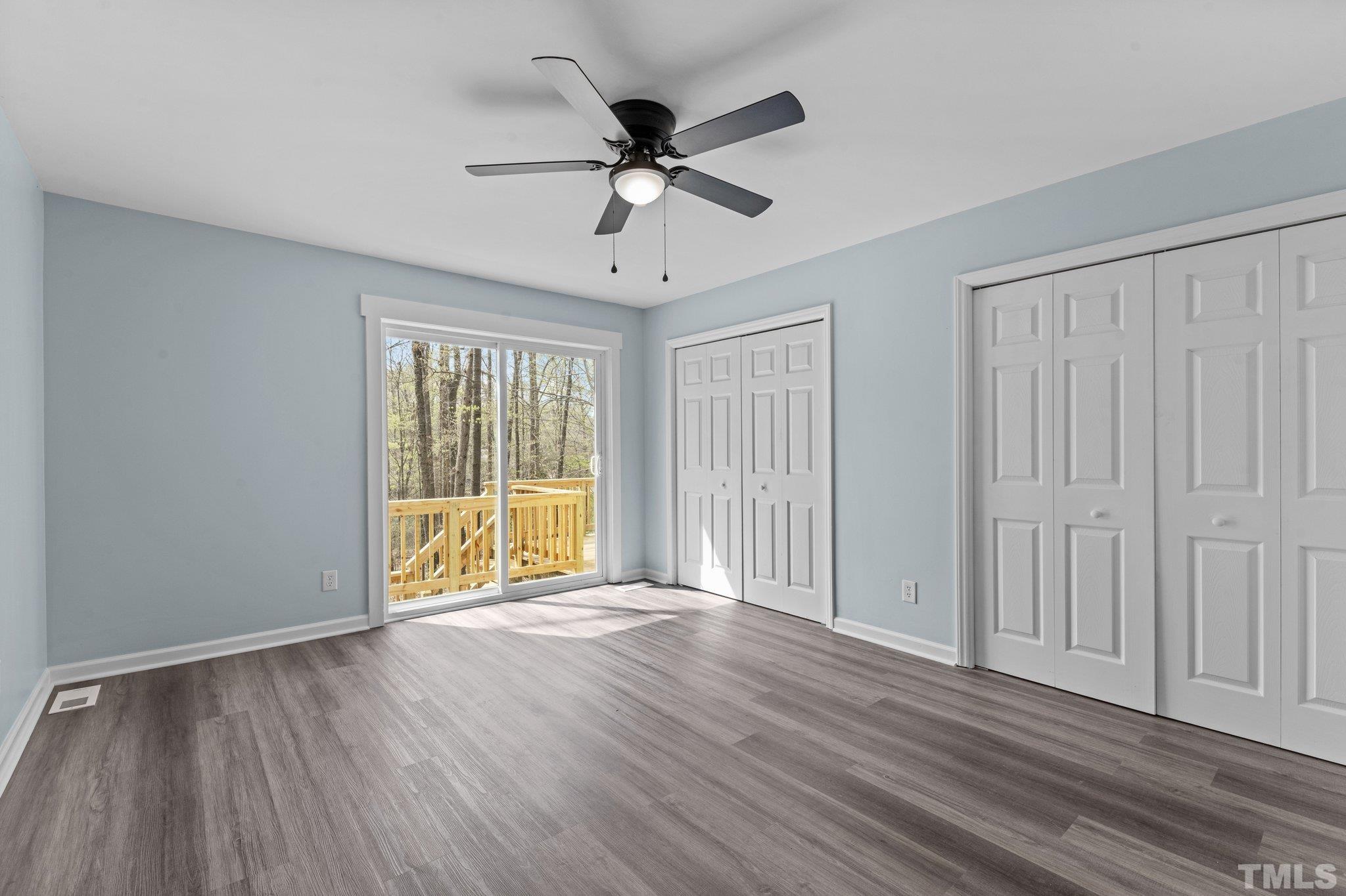 4006 Arckelton Drive, Unit 4006 & 4004 Raleigh, NC 27612 - Photo 22 of 34 a view of an empty room with wooden floor and a window