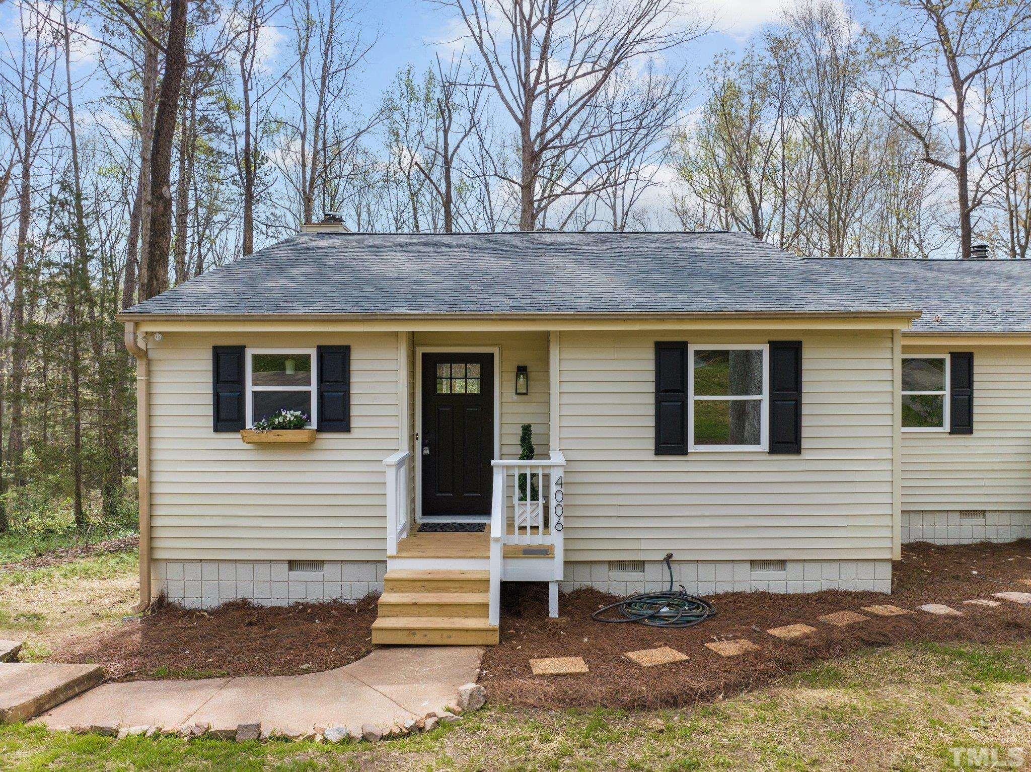 4006 Arckelton Drive, Unit 4006 & 4004 Raleigh, NC 27612 - Photo 24 of 34 a view of a house with a yard