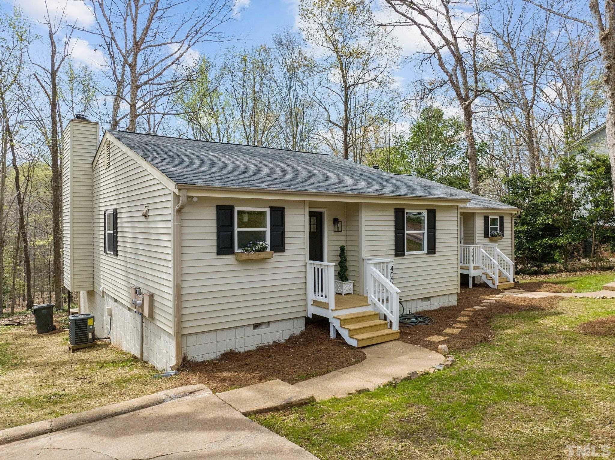 4006 Arckelton Drive, Unit 4006 & 4004 Raleigh, NC 27612 - Photo 25 of 34 a view of a house with a yard