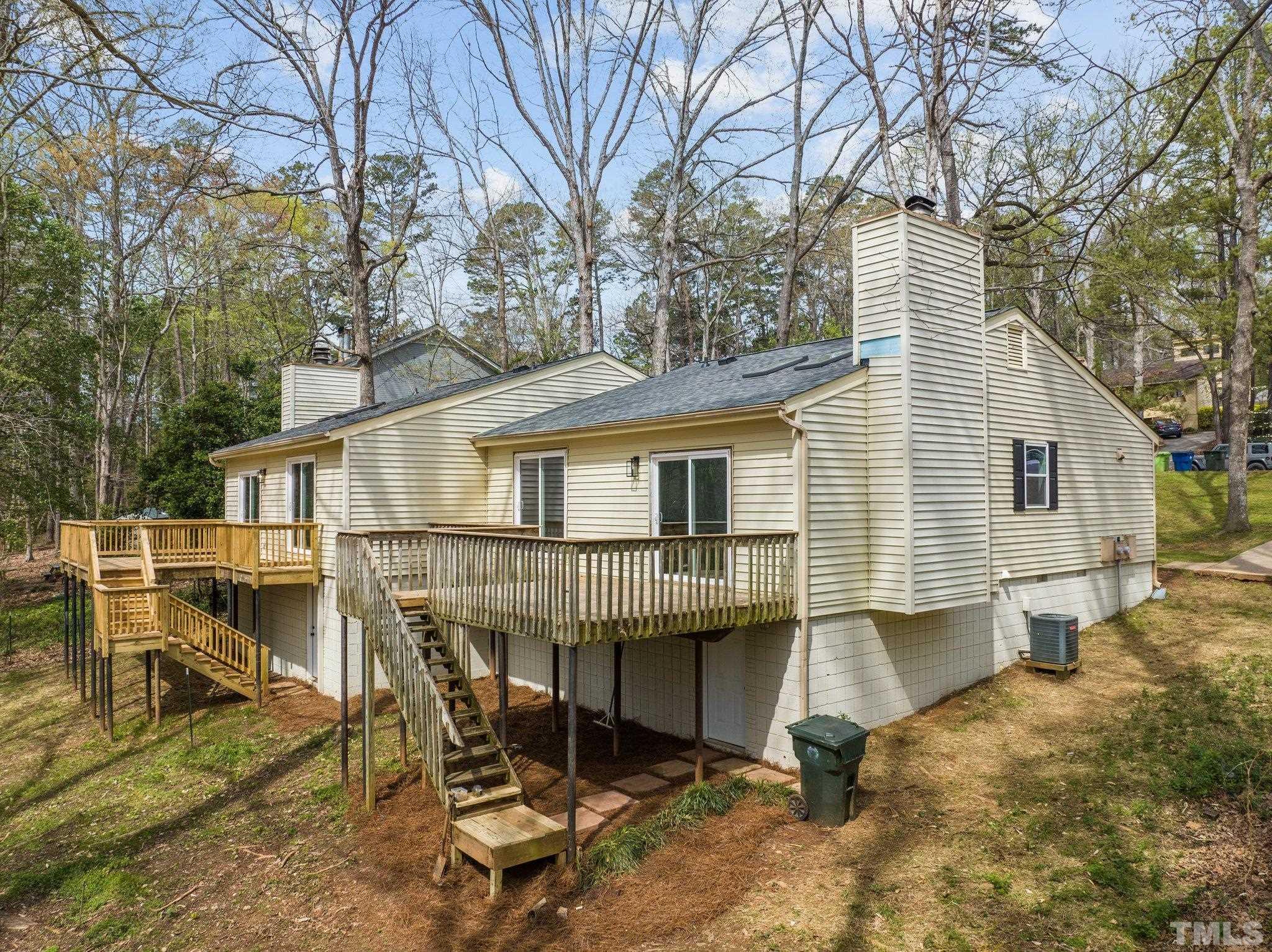 4006 Arckelton Drive, Unit 4006 & 4004 Raleigh, NC 27612 - Photo 27 of 34 a white house that has a table and chairs in it
