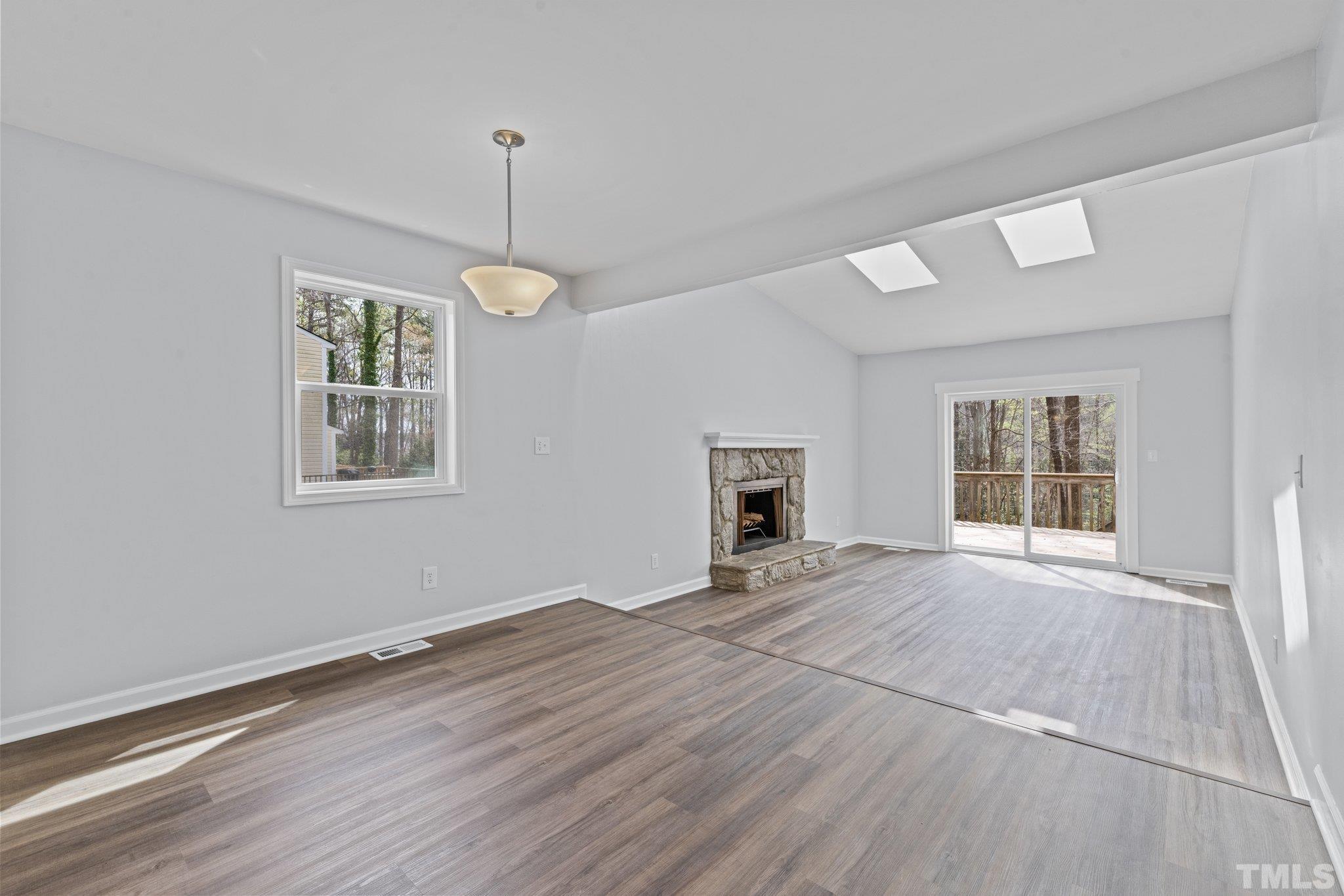 4006 Arckelton Drive, Unit 4006 & 4004 Raleigh, NC 27612 - Photo 30 of 34 a view of an empty room with window and wooden floor