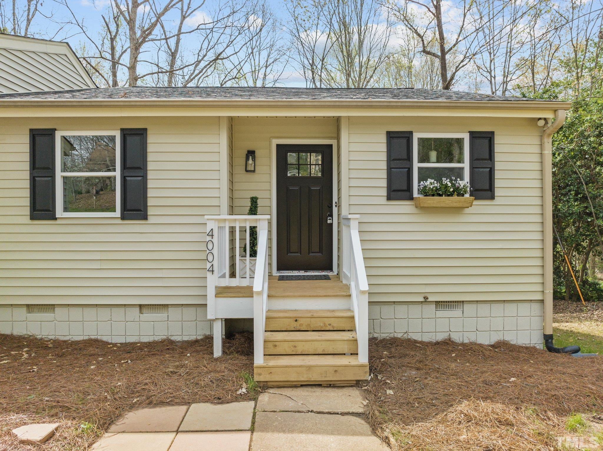 4006 Arckelton Drive, Unit 4006 & 4004 Raleigh, NC 27612 - Photo 3 of 34 a view of a house with a door and a tree