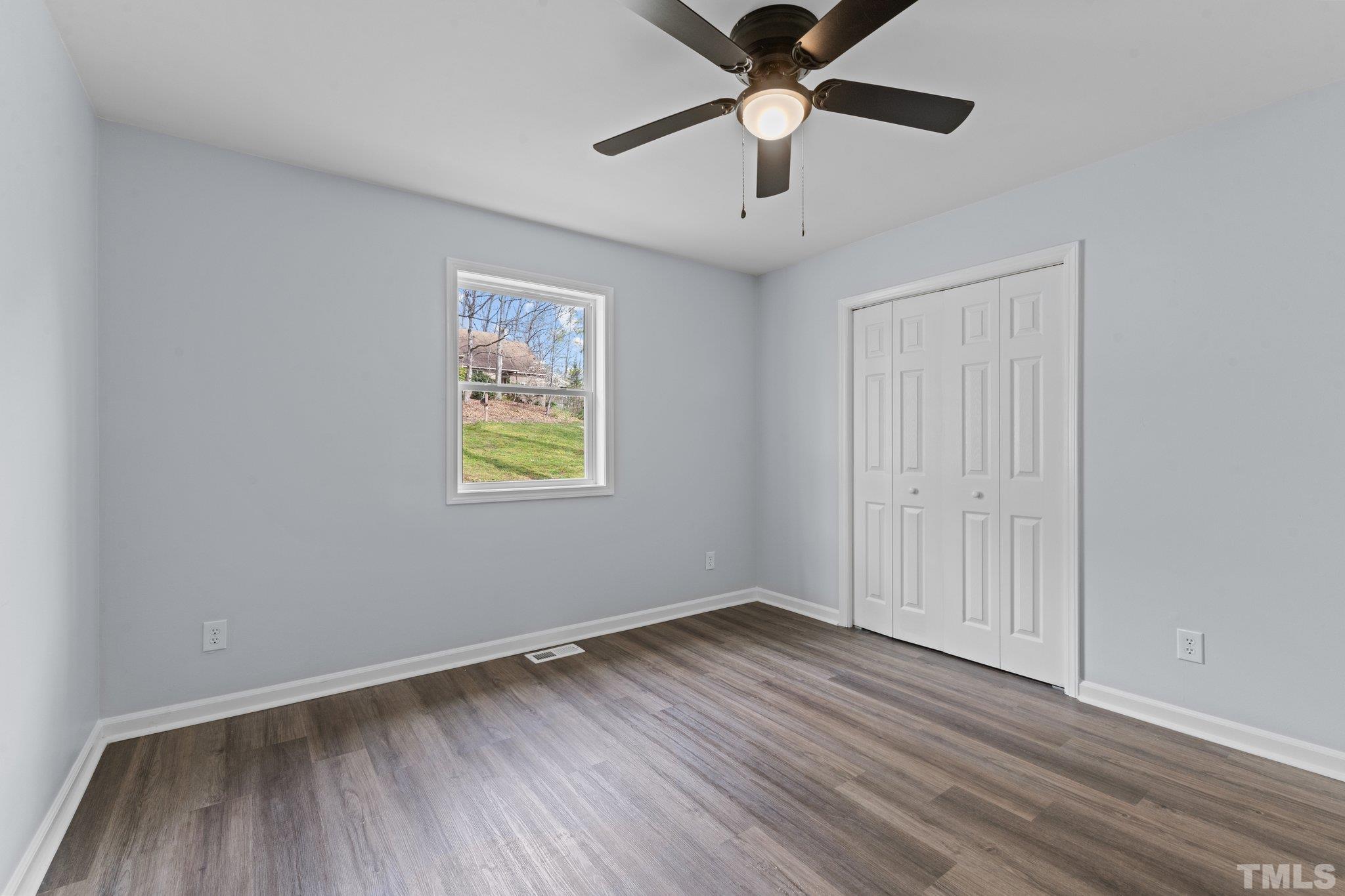 4006 Arckelton Drive, Unit 4006 & 4004 Raleigh, NC 27612 - Photo 31 of 34 an empty room with wooden floor and windows