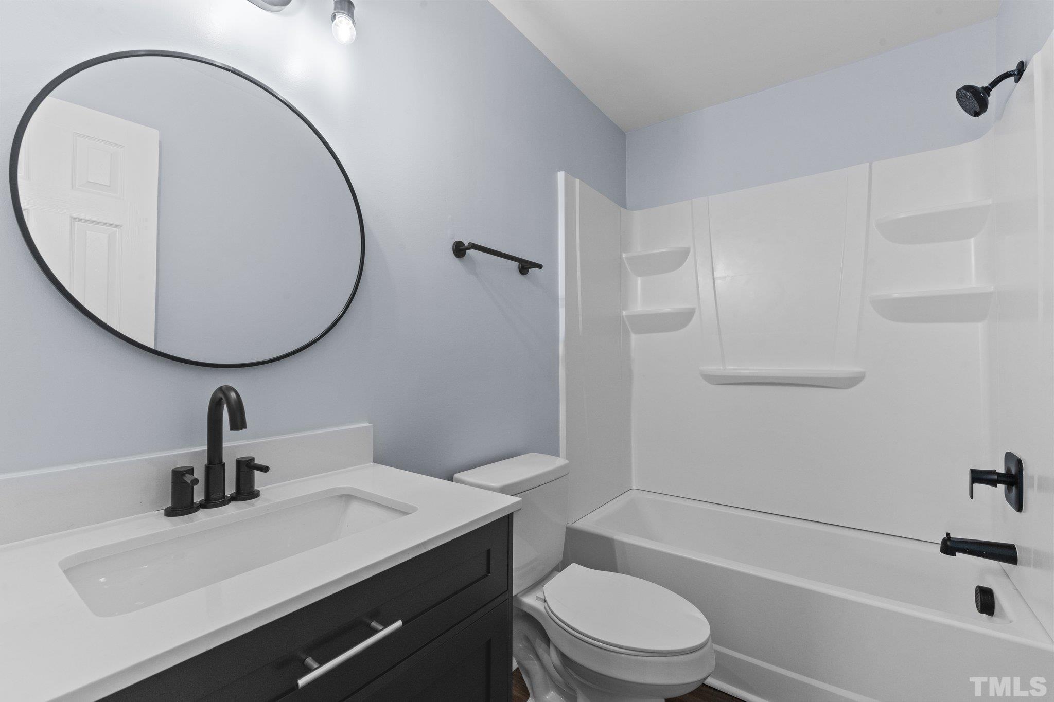 4006 Arckelton Drive, Unit 4006 & 4004 Raleigh, NC 27612 - Photo 32 of 34 a bathroom with a sink a toilet and a mirror