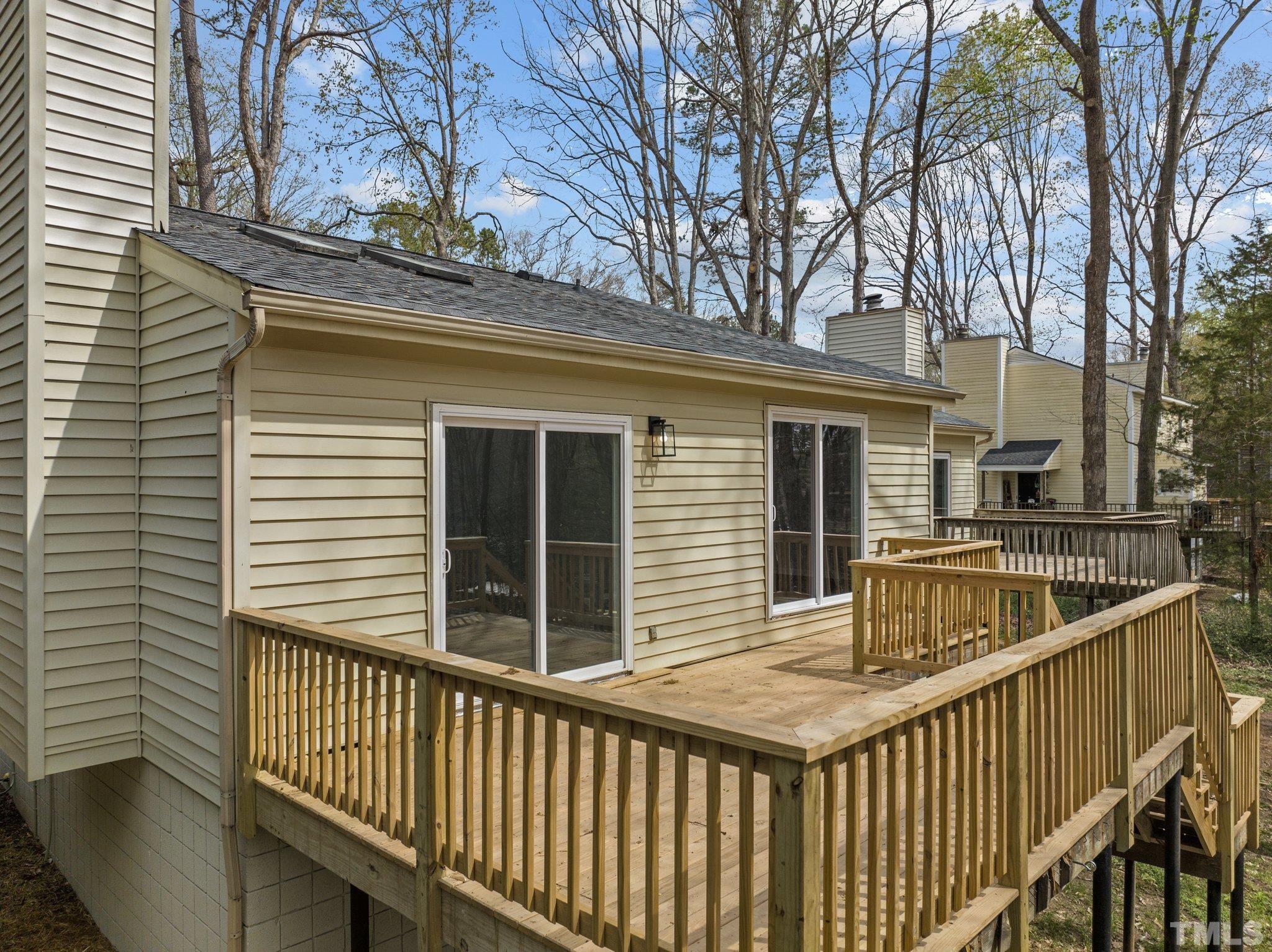 4006 Arckelton Drive, Unit 4006 & 4004 Raleigh, NC 27612 - Photo 8 of 34 a view of house with deck and trees