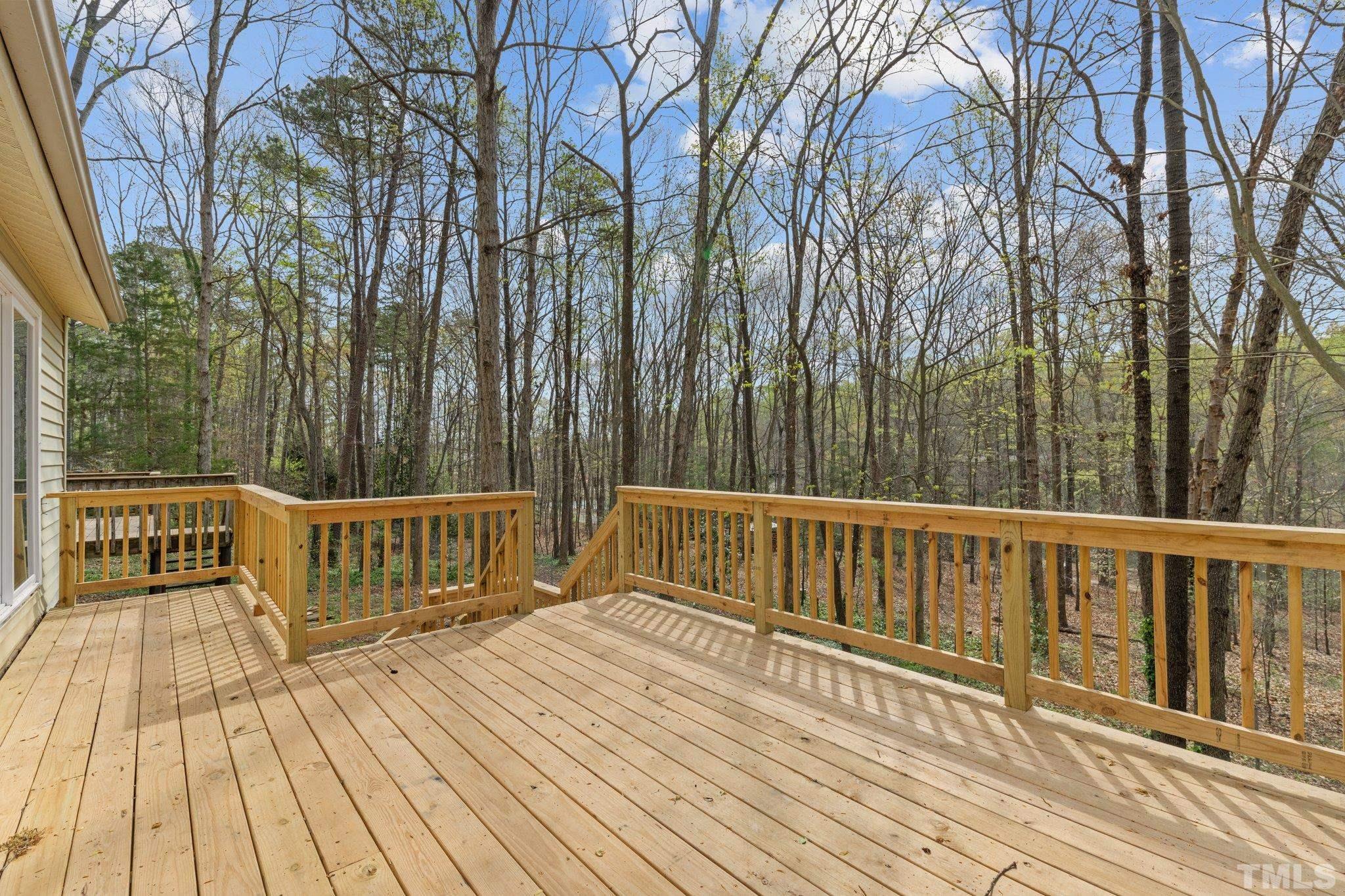 4006 Arckelton Drive, Unit 4006 & 4004 Raleigh, NC 27612 - Photo 10 of 34 a view of balcony with wooden floor and fence