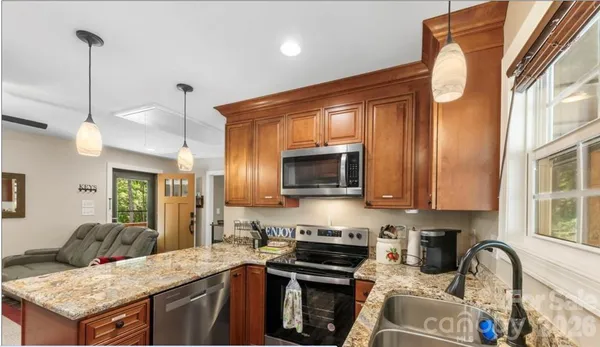 a kitchen with a stove a sink and a microwave