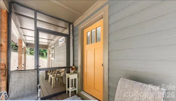a backyard of a house with table and chairs