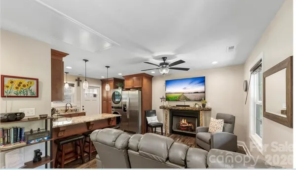 a living room with furniture a fireplace and a flat screen tv