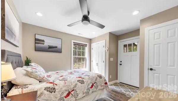 a bedroom with a bed and a window