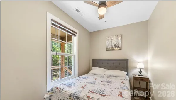 a bed sitting in a bedroom and a lamp