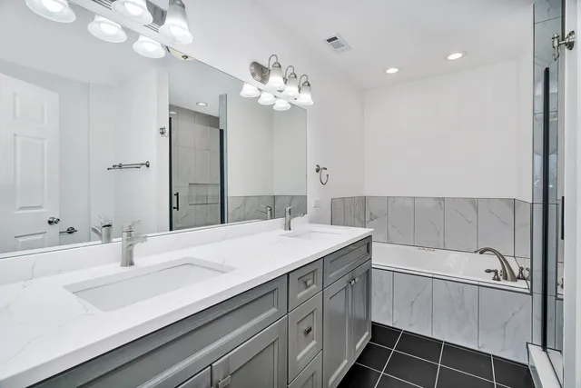 a bathroom with a sink a large mirror and a shower