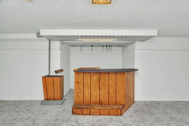 a view of a wooden balcony with a floor to ceiling window
