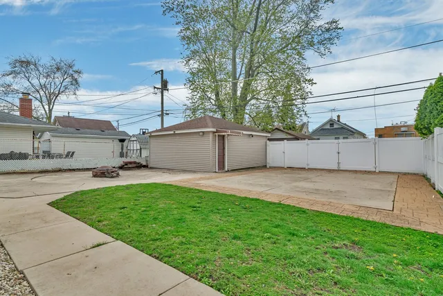 a view of a white house with a street