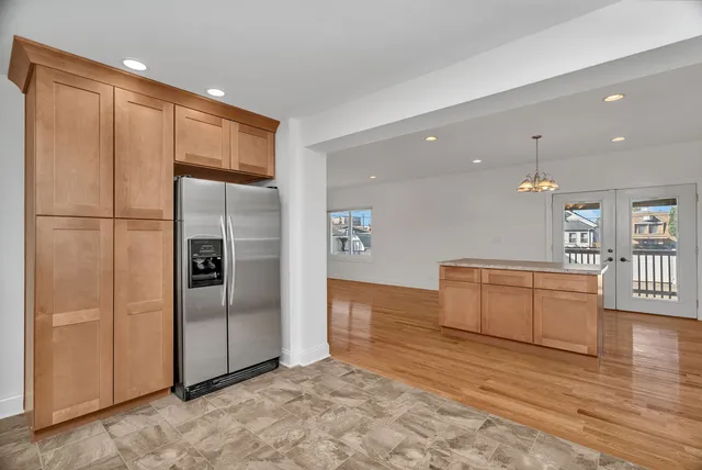 a view of a kitchen with a refrigerator and a sink