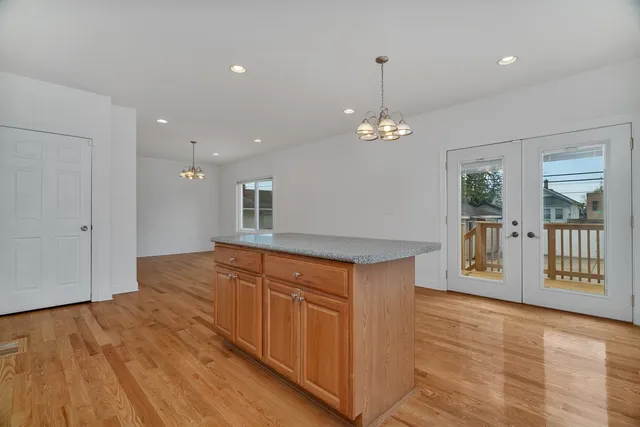 a large kitchen with stainless steel appliances granite countertop a granite counter tops and a wooden floors