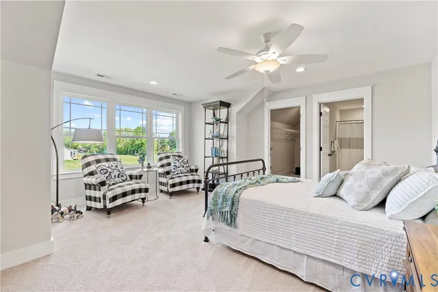 a bedroom with furniture and large windows