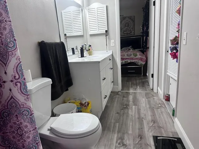 a bathroom with a sink toilet and shower