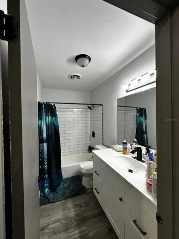 a bathroom with a double vanity sink toilet and mirror