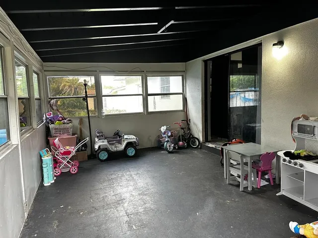a view of a garage with two chairs and a large window