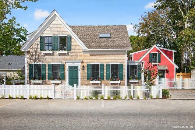 a view of a house with a small yard and plants