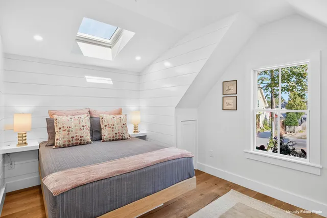 a bedroom with a large bed and a window