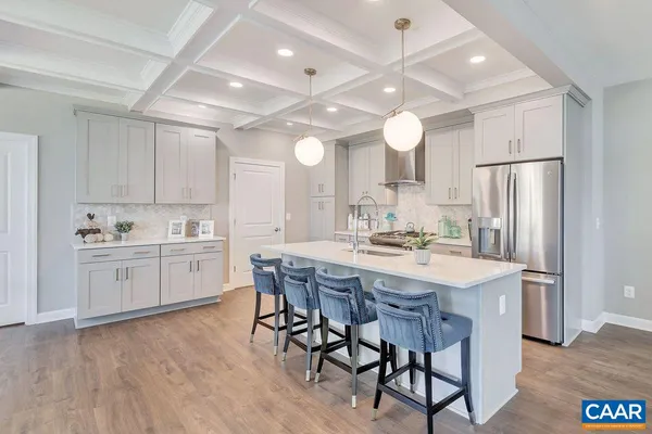 a kitchen with center island table and chairs