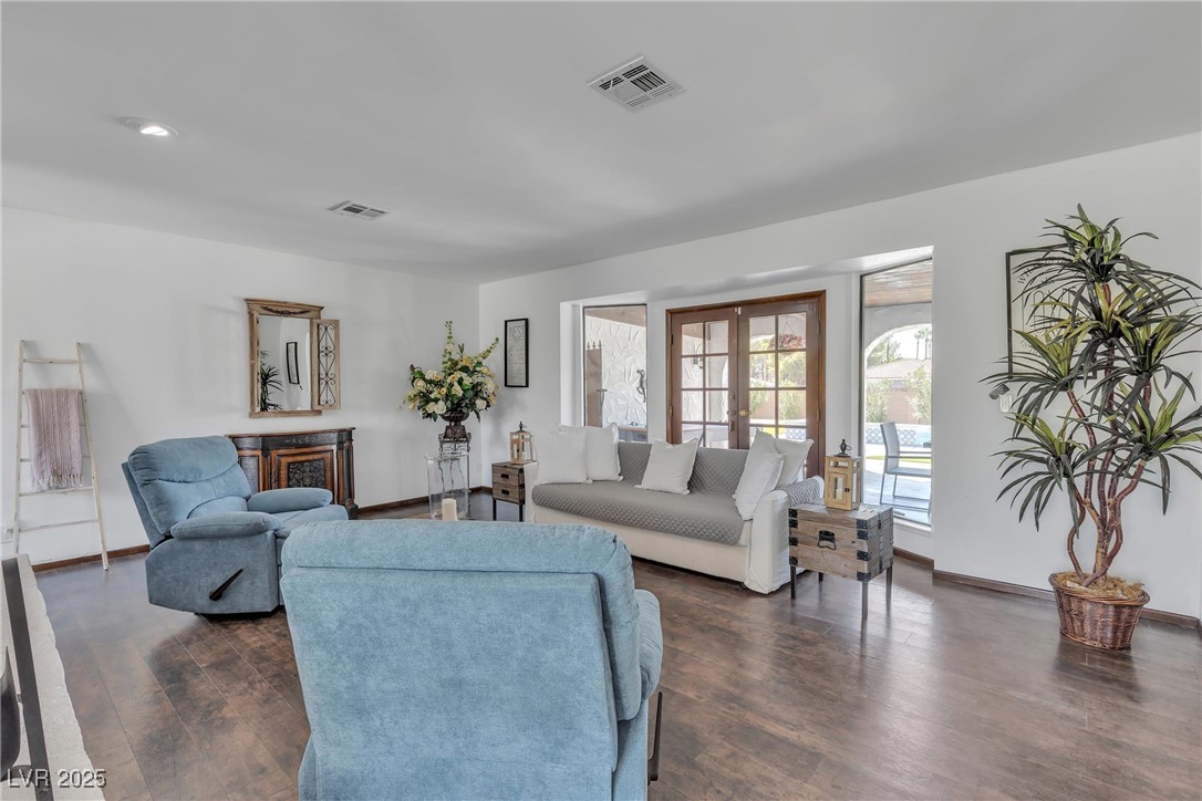 1780 Westwind Road Las Vegas, NV 89146 - Photo 26 of 61 Spacious Living room with cozy fireplace and french doors to access the beautiful backyard