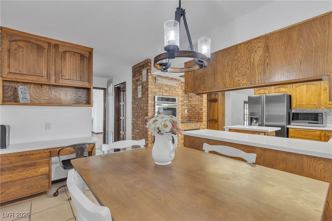 1780 Westwind Road Las Vegas, NV 89146 - Photo 35 of 61 Gourmet Kitchen with Quartz countertop, island, custom brick and built in range and double ovens