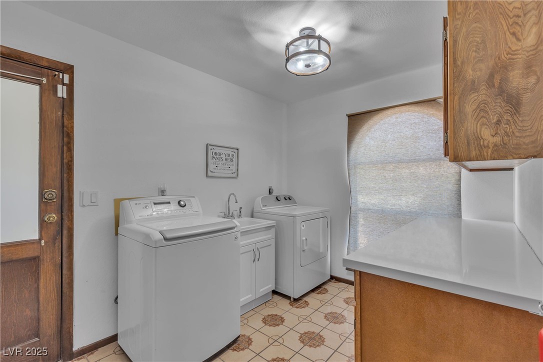 1780 Westwind Road Las Vegas, NV 89146 - Photo 36 of 61 Full size laundry room with utility sink and door to exterior