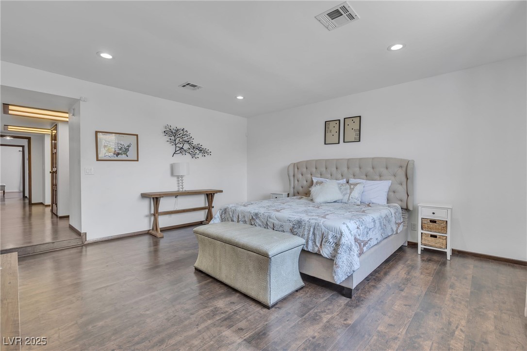 1780 Westwind Road Las Vegas, NV 89146 - Photo 52 of 61 Primary Bedroom with sitting area and view to sparkling swimming pool and waterfall spa