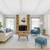 a living room with furniture fireplace and window