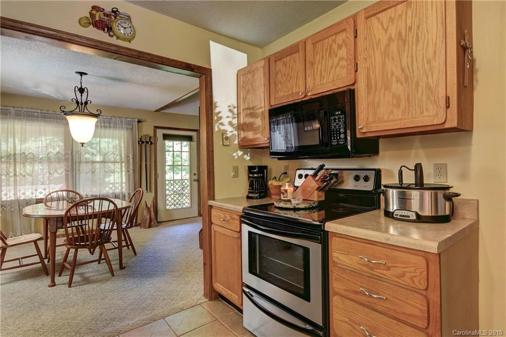 263 Laurel Branch Road Maggie Valley, NC 28751 - Photo 12 of 32 a kitchen with stainless steel appliances granite countertop a stove a sink and a microwave
