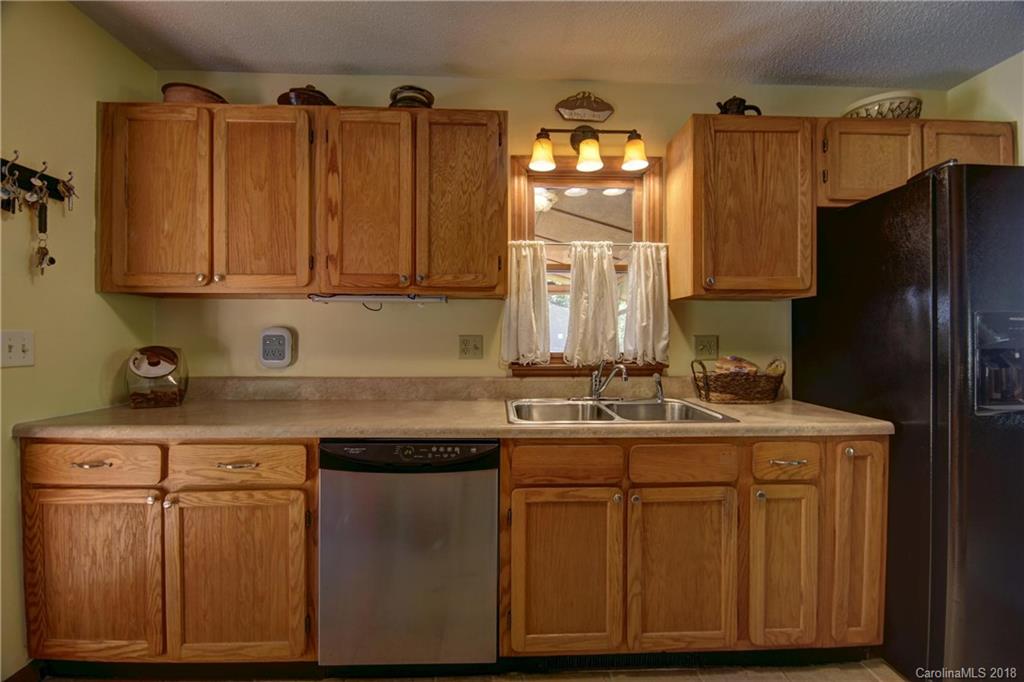 263 Laurel Branch Road Maggie Valley, NC 28751 - Photo 13 of 32 a kitchen with a sink and cabinets
