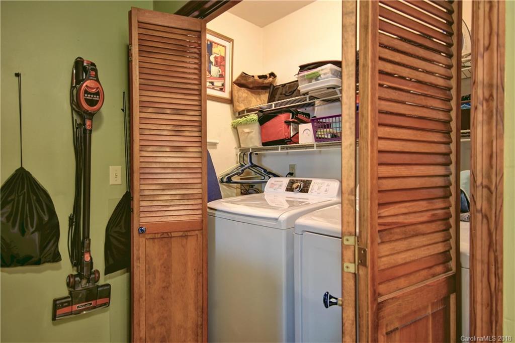 263 Laurel Branch Road Maggie Valley, NC 28751 - Photo 14 of 32 a utility room with a refrigerator and a table