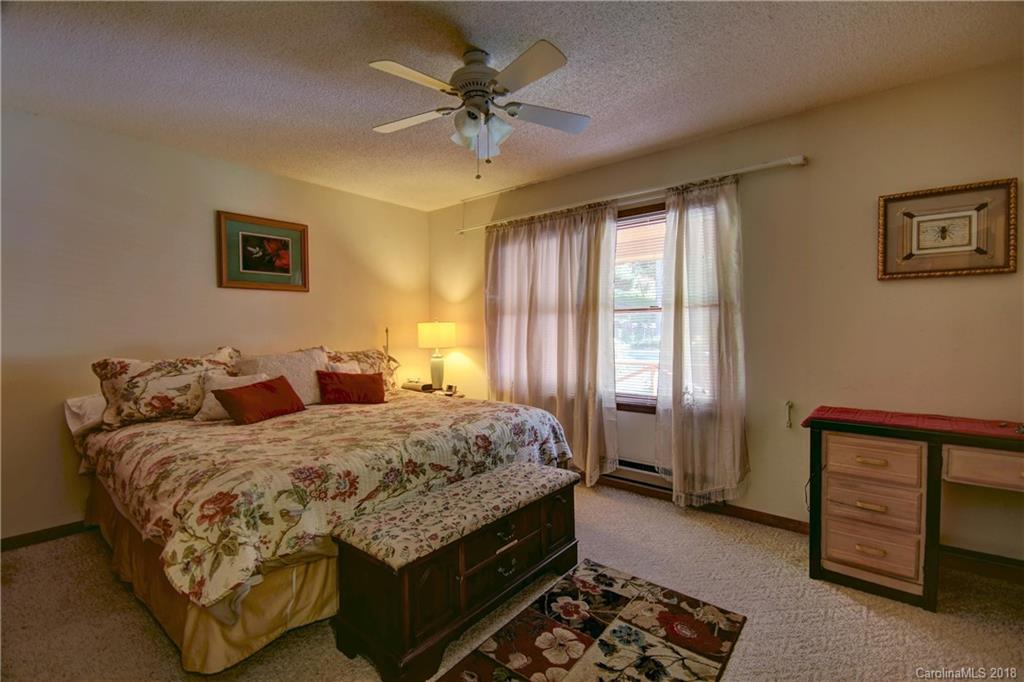 263 Laurel Branch Road Maggie Valley, NC 28751 - Photo 15 of 32 a bedroom with a bed and a dresser